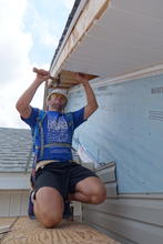 Abra installing the soffit. 