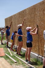 Nailing sheeting onto the house. 